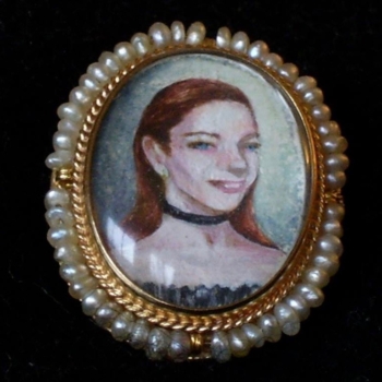 An earring feauring a tiny portait painted on mother of pearl.