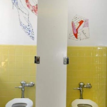 Warhol-inspired shoe art in restroom.